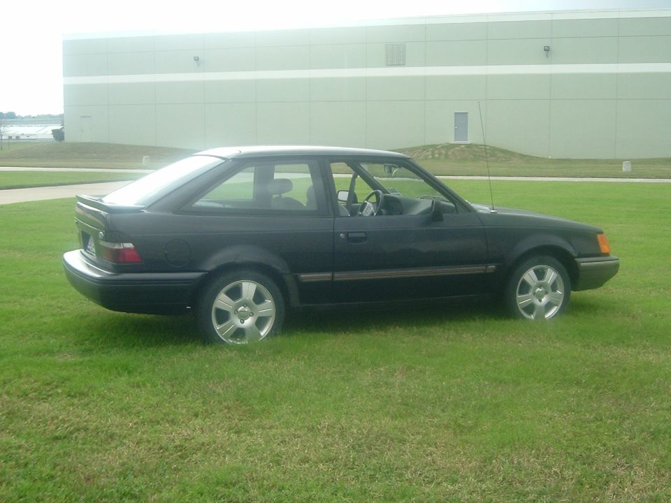 Black 1989 Ford Escort coupe side view