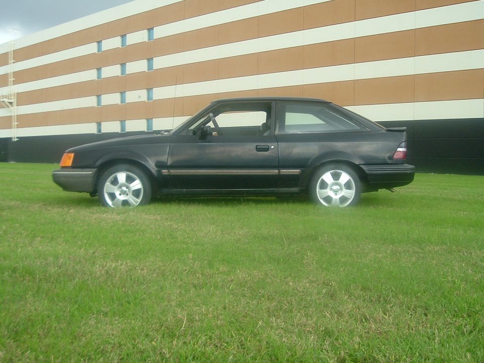 1989 Ford Escort coupe, side view, dark color