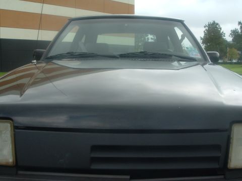 1989 Ford Escort - Front view of a 1989 Ford Escort, captured from a low angle.