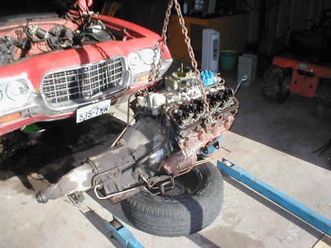 1973 Ford Ranchero - Engine and transmission assembly suspended by chains, removed from a 1973 Ford Ranchero.