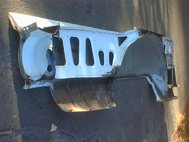 White louvered inner fender wheelhouse panel on dark ground