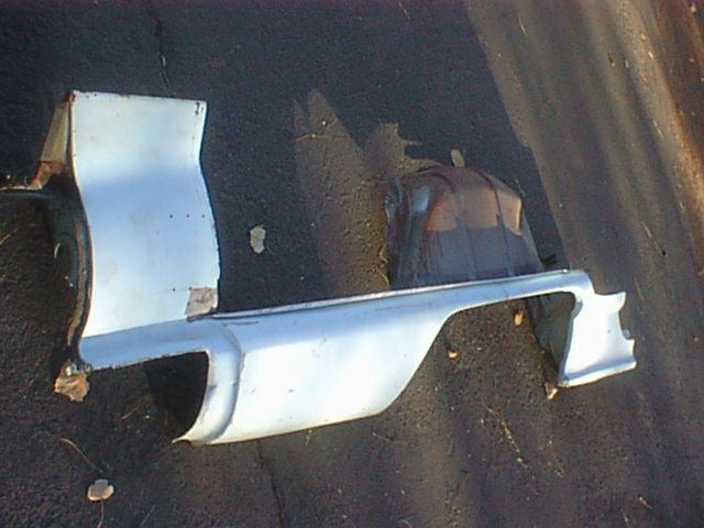 White inner fender bracket pieces with amber lens on pavement