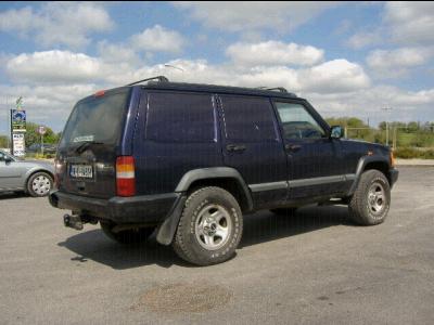 2000 Jeep Cherokee - This 2000 Jeep Cherokee has been converted into a van, seen from the rear-left.