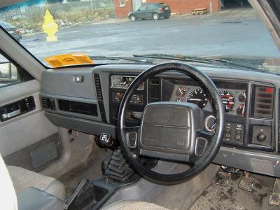 2000 Jeep Cherokee - The interior of a Jeep Cherokee shows a dashboard with gauges and a steering wheel.