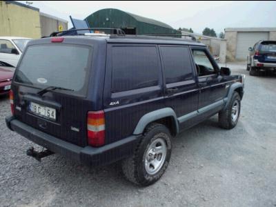 2000 Jeep Cherokee - This Jeep Cherokee SUV is seen from a 3/4 front angle in an outdoor lot.