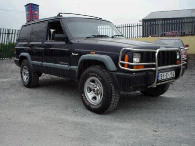 2000 Jeep Cherokee - This 2000 Jeep Cherokee Sport is viewed from a three-quarter front angle, showing its dark blue paint and aftermarket bull bar.