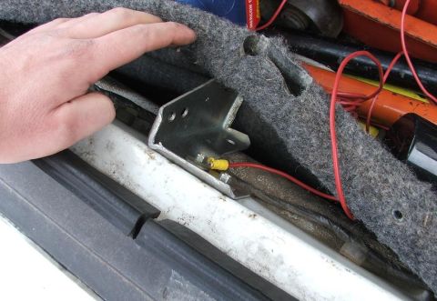 1985 Ford Crown Victoria LTD - A hand is shown near the trunk's interior, highlighting wiring and a metal bracket.