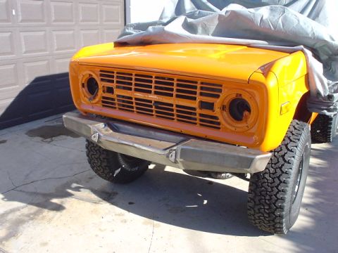 1977 Ford Bronco - Front view of a 1977 Ford Bronco with a custom bumper and a cover over the hood.