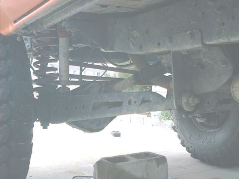 1978 Ford Bronco - Close-up of vehicle undercarriage, focusing on suspension and drivetrain parts.