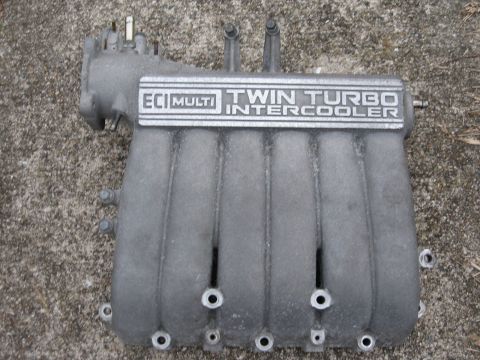 1991 Mitsubishi 3000GT - Intake manifold with ECI MULTI TWIN TURBO INTERCOOLER labeling.