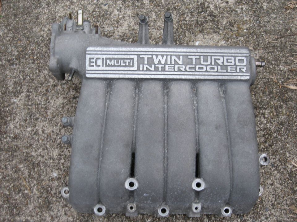 Intake manifold with ECI Multi Twin Turbo Intercooler cast lettering on concrete
