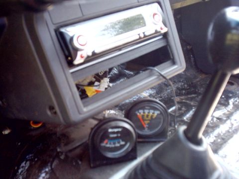 1988 Toyota 4Runner - Interior view of a vehicle's dashboard, highlighting aftermarket audio and gauge installations.