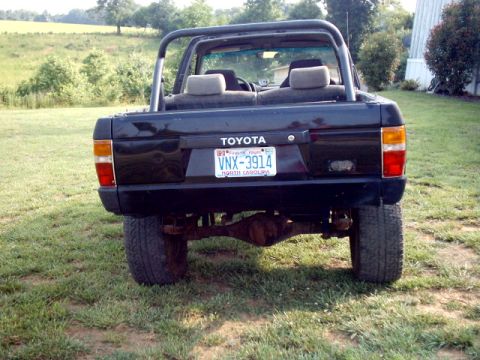 1988 Toyota 4Runner - Rear view of a black 1988 Toyota 4Runner SUV parked on a grassy area.