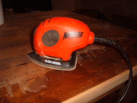 1988 Ford Bronco - A Black & Decker Mouse sander rests on a wooden surface, possibly in the process of refinishing.