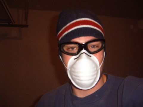 1988 Ford Bronco - A person is shown wearing a dust mask and protective goggles, possibly for a refinishing project.