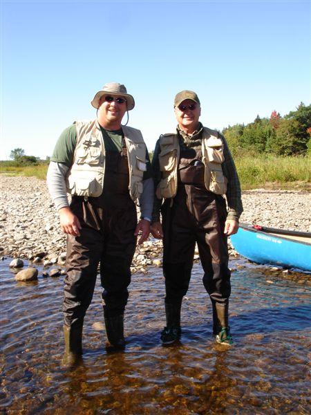 1984 Ford Bronco - Two anglers stand in the water, ready for a day of fishing with a canoe at the ready.