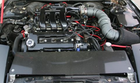1995 Ford Probe - Engine bay of a Mazda V6, aftermarket modifications and carbon fiber accents.