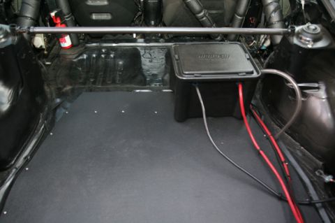 1995 Ford Probe - The trunk of the car shows a battery box, wiring, and a roll cage.