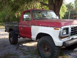 1974 Ford F-100 - This Ford F-100 pickup truck has a distinctive two-tone paint job and appears to be modified for off-road use.