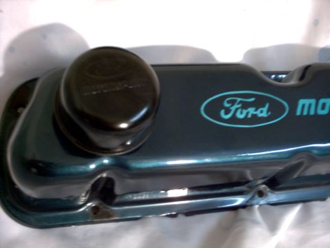 1965 Ford Mustang - Ford valve cover with blue oval logo and 'motor' text, plus a black oil cap.