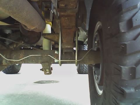 1995 Ford Bronco - Close-up of the rear suspension and tire assembly on a 1995 Ford Bronco.