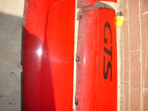 1997 Ford Probe - This red car part, possibly a fender or door panel, displays the "GTS" designation.