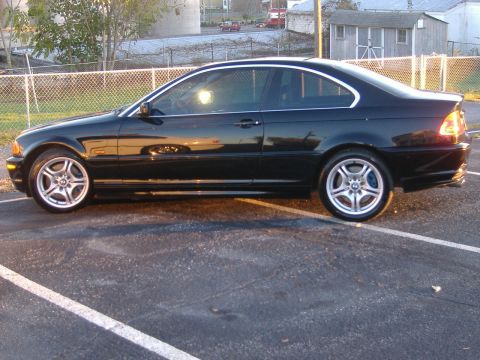 2001 BMW 3 Series - Side view of a black coupe with distinctive silver wheels and blue brake calipers.