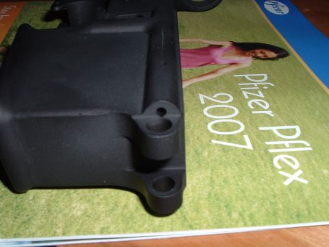 1995 Mercury Grand Marquis - A black plastic component rests on a document text and an image of a woman.