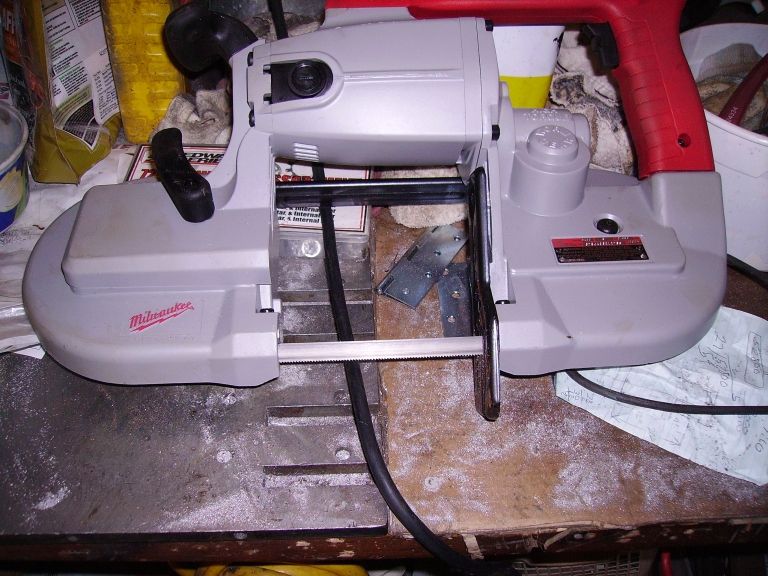 Milwaukee portable band saw with red handle