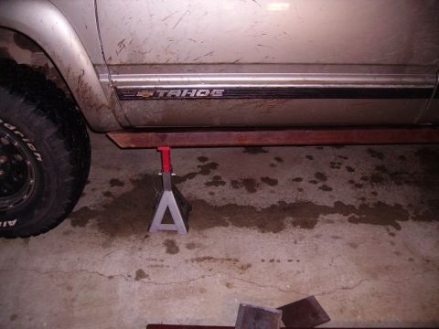 2000 Chevrolet Tahoe - Side view of a 2000 Chevrolet Tahoe on a jack stand, showing the 'TAHOE' badge.