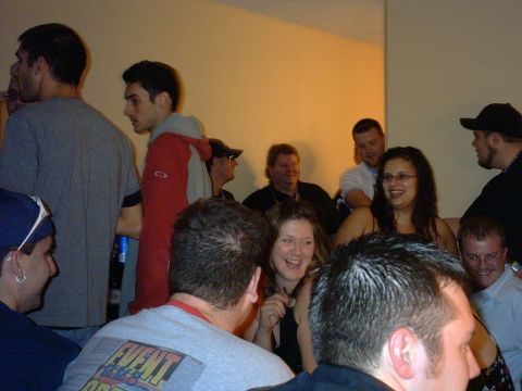 1997 Ford Probe - A social gathering of people indoors, with several individuals engaged in conversation.