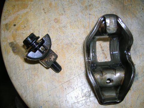 1994 Ford Bronco - Close-up of an engine rocker arm and a separate bolt assembly.