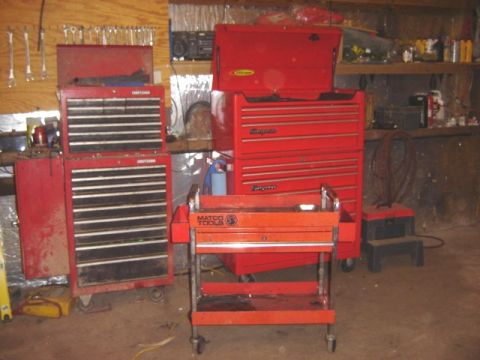 1992 Ford Bronco - A collection of red tool chests and a rolling cart are organized in a workshop setting.