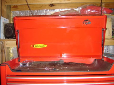 1992 Ford Bronco - An open red toolbox displays various tools and a small sticker of a truck on its lid.