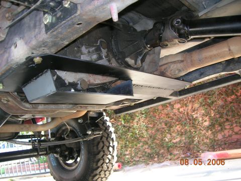 1985 Ford Bronco - Underside view of a transfer case skid plate installed on a vehicle.