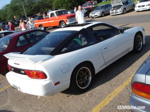 1993 Mazda MX-6 - A white 1993 Nissan 240SX coupe is seen from the rear-three-quarter view in a parking lot.