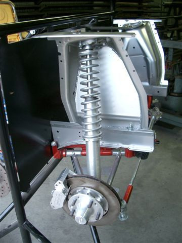1965 Ford Mustang - Close-up of a front suspension assembly, a coilover shock and disc brake system.