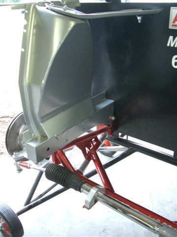 1965 Ford Mustang - Assembly of a car's front suspension and fender structure, showing red frame parts.