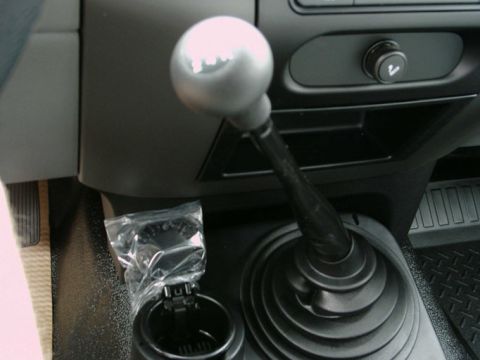 1997 Ford F-150 - Close-up of a manual transmission shifter and ashtray in a truck's interior.