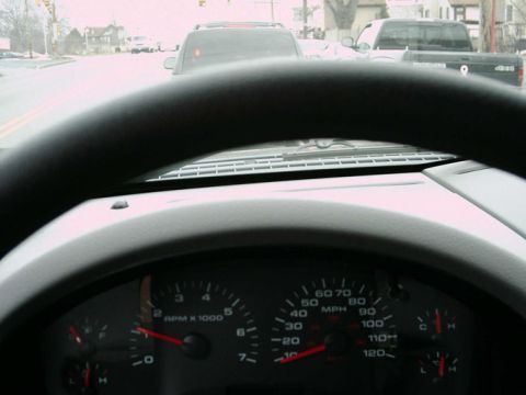 1997 Ford F-150 - Interior view of a truck's dashboard with a road and other vehicles visible through the windshield.