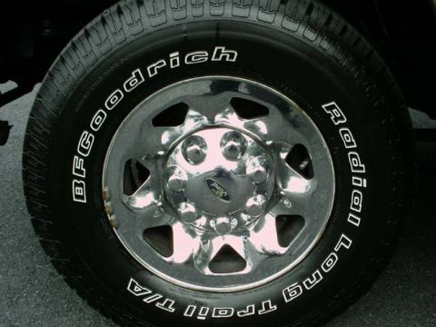 1997 Ford F-150 - Close-up of a BFGoodrich Radial Long Trail T/A tire and chrome wheel.