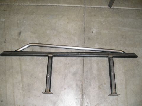 1993 Ford Bronco - Two pieces of custom fabricated steel tubing, possibly for a roll cage, are shown on a concrete floor.