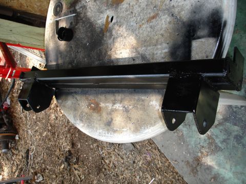 1989 Ford Bronco - A black trailer hitch receiver is shown resting on a workbench, likely after being painted.