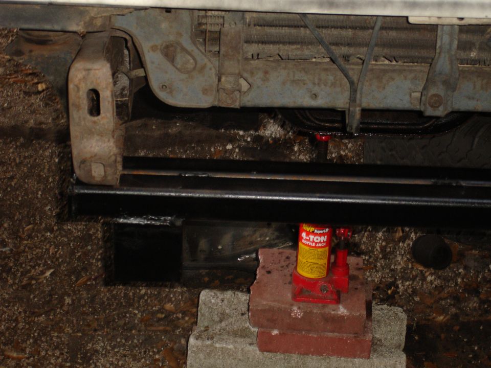Front bumper and grille area of a vehicle supported by a hydraulic jack