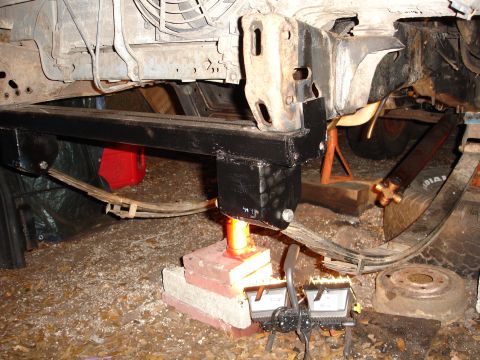 1989 Ford Bronco - Custom frame modification in progress, showing suspension components and jack support.