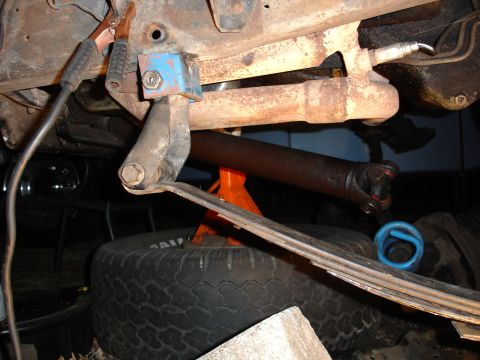 1989 Ford Bronco - Close-up view of a vehicle's undercarriage, showing suspension components and repair work in progress.