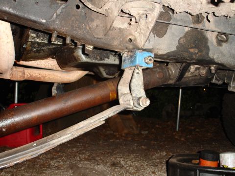 1989 Ford Bronco - Close-up of vehicle undercarriage, focusing on suspension and drivetrain components.