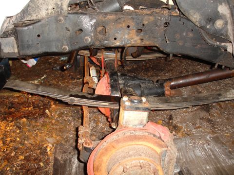 1989 Ford Bronco - Undercarriage view showing suspension parts and frame of a vehicle.