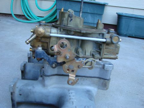 1979 Ford Bronco - Close-up of a Holley carburetor and intake manifold assembly.