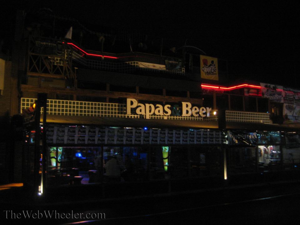 Papas and Beer nightclub exterior lit with red neon at night